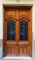 Fototapeta na wymiar Old wooden doors of a doorway in a street of Madrid, Spain