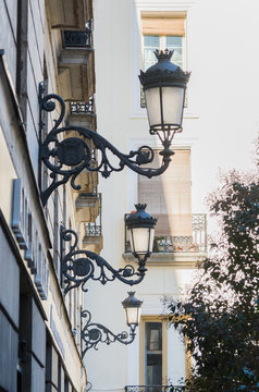 Three street lamps aligned in a street in Madrid, Spain