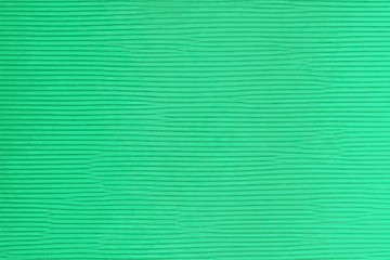 Ribbed texture of a green cardboard with horizontal lines