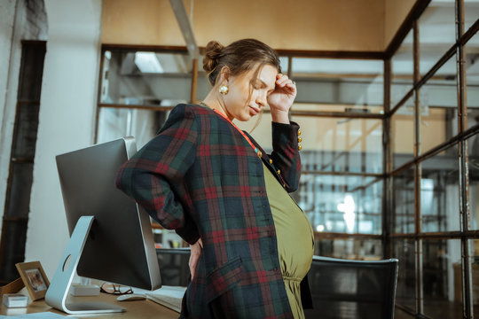 Pregnant Businesswoman Feeling A Little Bit Dizzy At Work