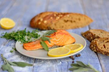 Roasted salmon with bread on rustic background