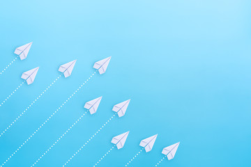 White paper planes on blue background. Business competition concept.