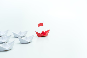 Red paper ship leading among white on white background, Leadership concept