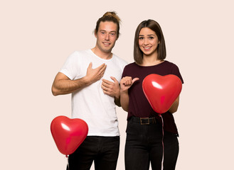 Fototapeta na wymiar Couple in valentine day with surprise facial expression over isolated background