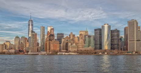 Fototapeta na wymiar Manhattan skyline and Hudson river daylight view with clouds in sky
