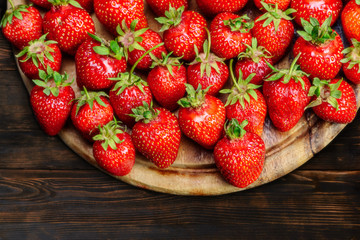 Strawberries on a plate on a wooden table