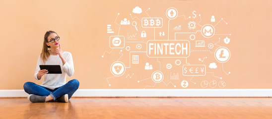 Cryptocurrency fintech theme with young woman holding a tablet computer