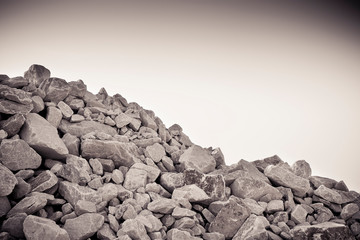 Pile of gravel, stones and cliffs of different sizes - toned image
