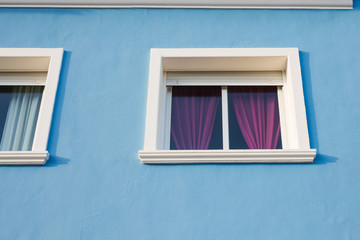 Design, architecture and exterior concept - Small white window on the blue facade