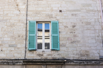 Fototapeta na wymiar Design, architecture and exterior concept - White and turquoise window on the stone facade