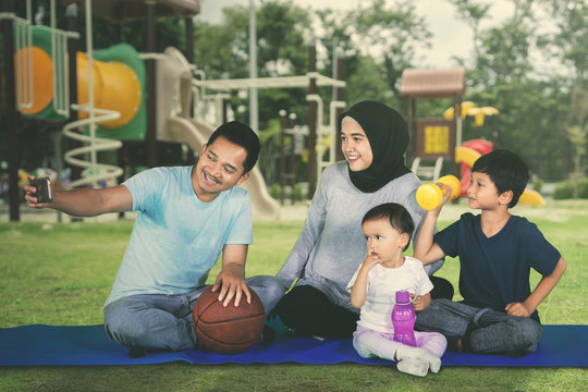 Happy Muslim family takes picture after exercises