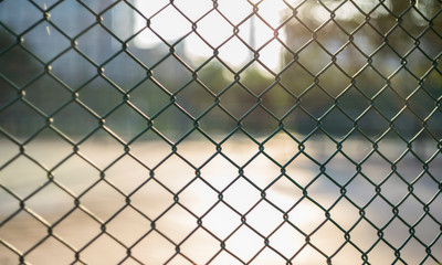 Close-up chain link fence , Sunset background