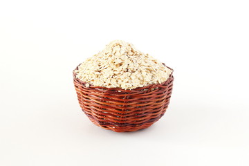 cut and Rolled oats flakes in basket isolated on white background.