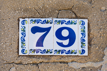 Fototapeta premium House number seventy nine 79 close up, ceramic plate