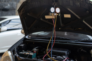 a car repaired by the air conditioner was tested by the dynamo using a pressure gauge