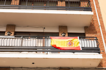 Flag of Spain hanging on the balcony of a house