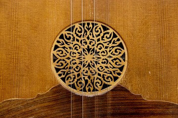 Close up at the circle of the sound hole at the soundboard of Greek traditional wooden music...