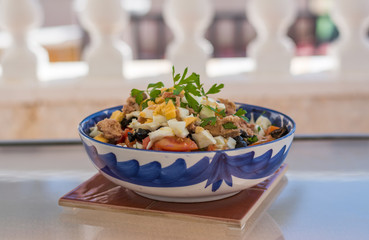 Salad with tuna in a blue bowl