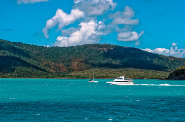 Boat in motion offshore from Airlie Beach in tropical, Queensland, Australia