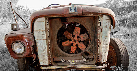Fototapeta na wymiar Rusty old engine compartment showing cooling fan and radiator
