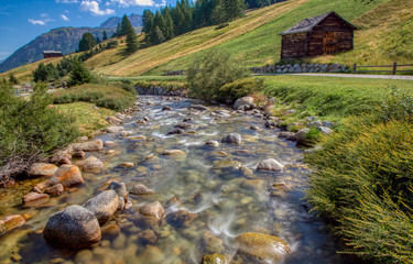 Picturesque valley with stream in Livigno, Italy