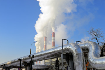 Thermal power plant, smoke from the chimney against blue sky