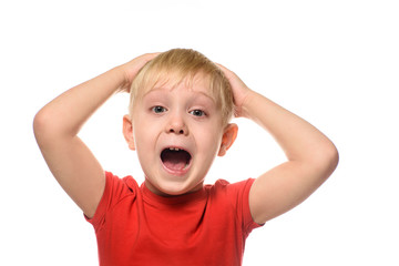 Screaming blond boy in a red t-shirt folded his arms behind his head. Isolate on white background.