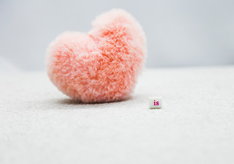 Pink heart on the white background