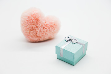 Pink heart with a gift box on the white background