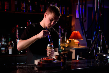 Shisha hookah with red hot coals. Modern hookah with coconut charcoal for relax and shisha smoke. Hookah and sparks from coals.