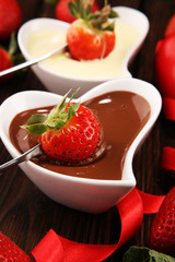 Valentine Chocolate fondue melted with fresh strawberries and dark and white chocolate. Tublips and sugar hearts.