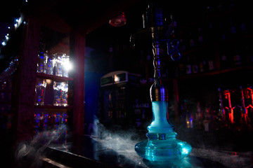 Hookah on the background of a bar, light, smoke, smog