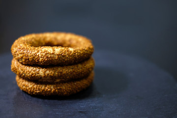 close up Turkish traditional sesame bagels - simit isolated on black background