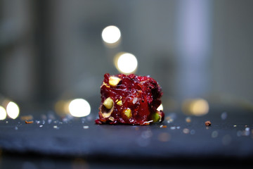 close up traditional Turkish delights isolated on dark background with light bokeh