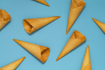 Ice cream cones pattern. Blue background. Sweet, summer concept. Flat lay. Top view. Closeup