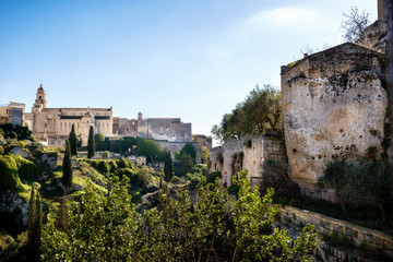 Fototapeta na wymiar Gravina in Puglia: picturesque landscape of the the deep ravine and the old town with the ancient cathedral, Bari, Apulia, Italy