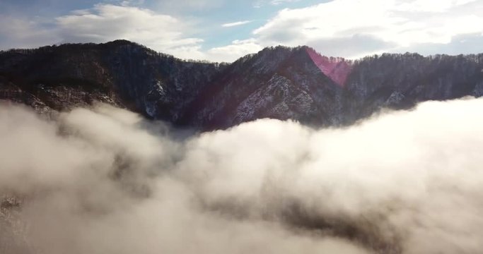 Fantastic panoramic fly through the fog under mountain