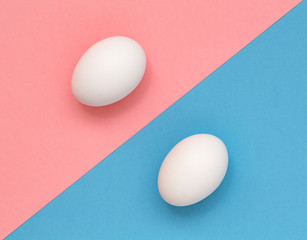 White Easter egg on pastel background. Happy Easter concept. Minimal concept. Flat lay. Top view.