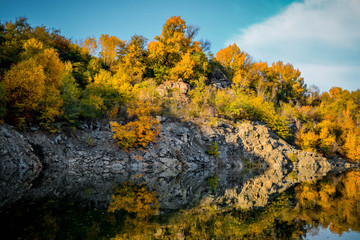 Old flooded quarry in autumn