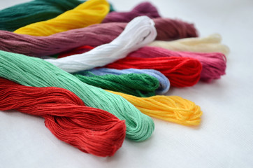 Set of colorful threads in a warm colors for embroidery and sewing