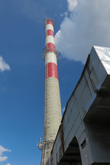 A high red-white concrete industrial chimney