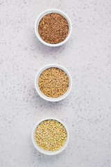 Obraz na płótnie Canvas Collection of different groats on grey background. Top view of buckwheat, chia, flax, amaranth, lentils, couscous, wheat