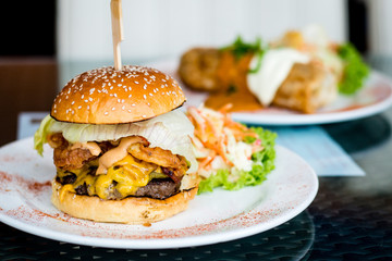 Texan Burger, Sweet pickles, fried onions, maple grilled bacon, cheddar cheese, grilled beef patty and Texan BBQ mayo