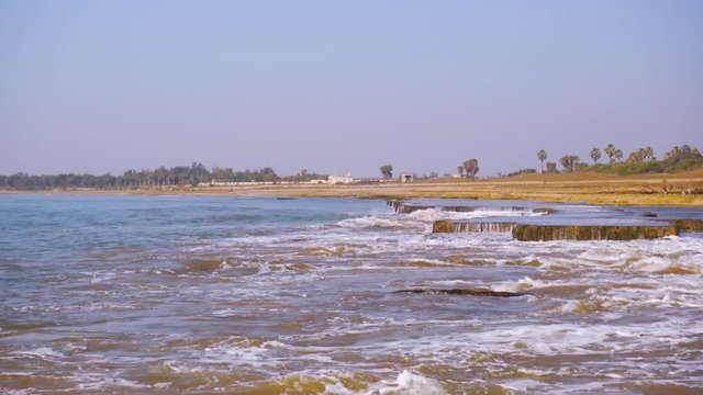 Zoom shot of waves dashing against rocks in the middle of the sea at Nagaon beach, Diu, Gujarat, India