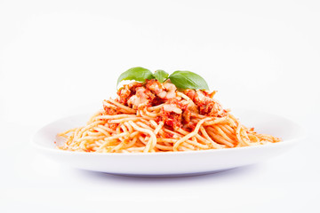 Spaghetti bolognese with melted parmesan cheese decorated with basil on a white background