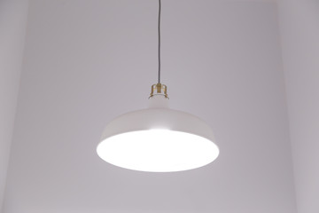 White lighting fixture with white wall background.