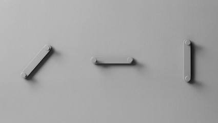 Fancy gray metal hangers on textured wall in studio