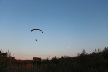 silhouette of a paraglider in the sunset