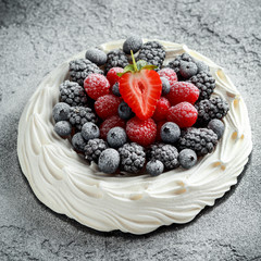 Berry Pavlova cake with fresh blueberries, strawberries and raspberries