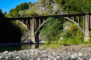 Abandoned arch railway bridge across the river. Aqueduct. Tkurchal. Tkvarchelli. Eastern Abkhazia.